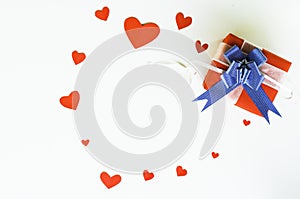 Top view Valentine day of gift red box,with blue bow and ribbon, with paper heart shape,on white background,concept Celebrating