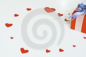 Top view Valentine day of gift red box,with blue bow and ribbon, with paper heart shape,on white background,concept Celebrating