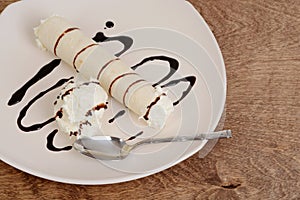 Top view vanilla ice cream crepe with chocolate sauce and spoon