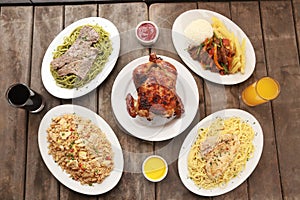 Top view of a variety of delicious meals served on a wooden table