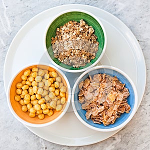 Top view of various cold breakfast cereal in bowls
