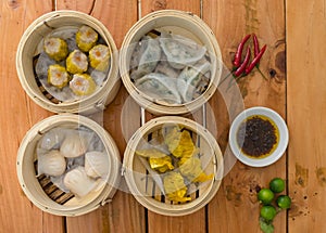 Top view of various Dim sum - Shumai,Shark fin, Shrimp and Chive, and Hargow. Served with chili oil and calamansi