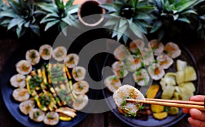 Top view vegan Vietnamese eating indoor restaurant, vegetarian rice rolls cut in slice with vegetable