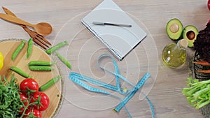 Top view of vegetables and fruits on the table with measuring tape. Concept of dieting, healthy eating, and body weight