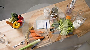 Top view of vegetables and fruits on wooden table in home kitchen. Balanced food, diet cooking and healthy lifestyle
