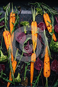 Top view of vegetables for roasting on dark background