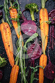 Top view of vegetables for roasting on dark background