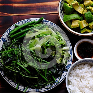 Top view vegetarian meal, boiled vegetables soy sauce and rice