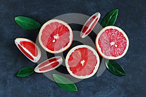 Top view of a vertical composition of slices and halves of grapefruits