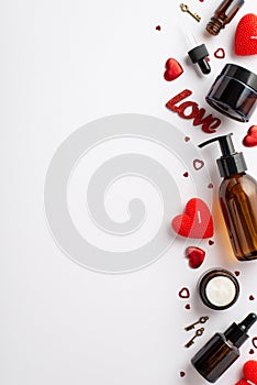 Top view vertical photo of amber glass cosmetic bottles red heart shaped candles small keys inscription love and confetti