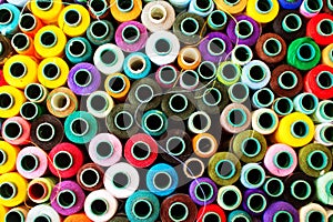 Top view of a vibrant collection of various colored thread spools