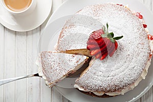 Top view of Victoria sponge cake with a cup of coffee