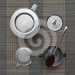 Top view of vietnamese coffee filter ingredients with ready cup of coffee on bamboo placemat