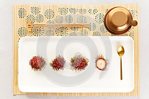 Top view of a Vietnamese coffee set up with rambutan in a light atmosphere