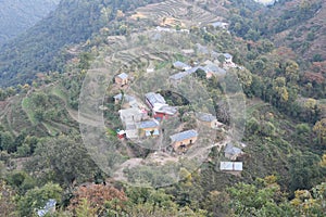 Top view of a village in hill state Himachal, India. Step fields and lush green landscape is clearly visible in the shot