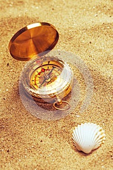 Top view of vintage compass in beach sand