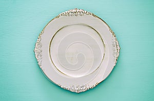 Top view of vintage white empty plate. Flat lay.