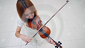 Top view of a violin being played by by a female musician