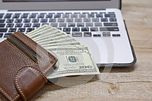Top view, wallet with dollar and computer