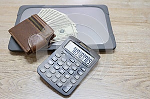 Top view, wallet with dollar and computer