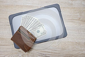 Top view, wallet with dollar and computer