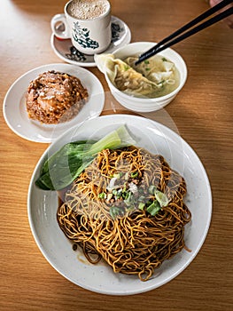Top view of wantan noodles with glutinous rice and white coffee. Staple breakfast for Malaysian Chinese photo