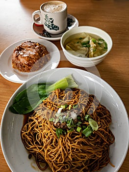 Top view of wantan noodles with glutinous rice and white coffe. Staple breakfast for Malaysian Chinese photo