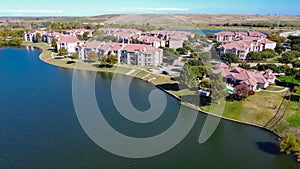 Top view waterfront apartment building with landfill community waste disposal in background near Dallas, Texas