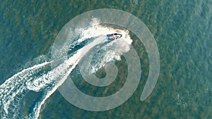 Top view waverunner rider crossing the sea.