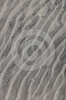 Top view of wavy lines on the sand on the beach