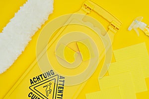 top view of wet floor sign and washing sponges