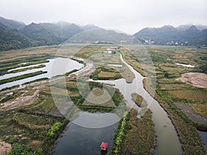 Top view of the wetlands of the island of Cat BA near the sea on land. Morning gloomy landscape of  countryside of Vietnam