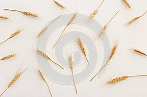top view of wheat crops over white wooden background. Symbols of jewish holiday - Shavuot
