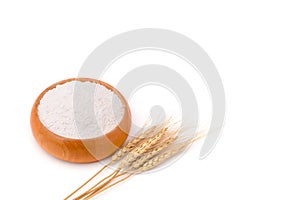 Top view of wheat flour in wooden bowl and rice ears isolated on white background