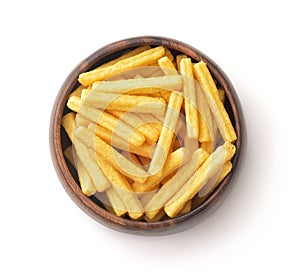 Top view of wheat puffed sticks in wooden bowl