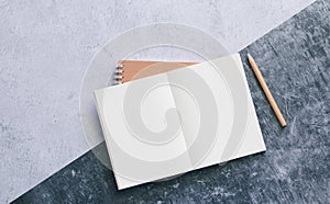 Top view of white binder blank notebook or diary or journal for writing text and message with pencil on concrete background with