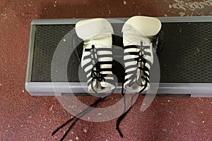 Top view of a white boxing gloves with black laces