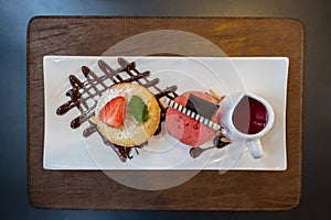 Top view of white chocolate lava cake served with strawberry ice-cream and sauce