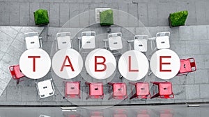 Top view of white circle table and chairs at outdoor with word