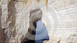 Top view of white cliff with arch. Action. Arched passage in white cliff - beautiful miracle of nature, created in