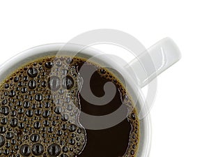 Top view of white cup of fresh black coffee with bubbles isolated on white background, close up