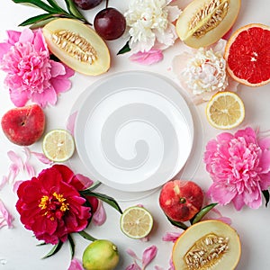 Top view of white empty plate, fruit and flowers. Flat lay, spring summer season holiday, femenine wedding table setting,