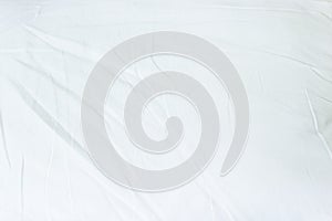 Top view of white fabric bed sheet texture background