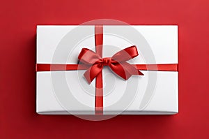 Top View of White Gift Box Tied with Red Ribbon Bow, Isolated on a Vibrant Red Background.