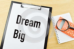 Top view of white paper written with DREAM BIG