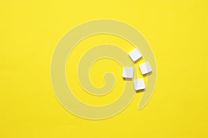 top view of white pills on yellow background