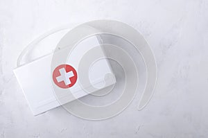 Top view of white plastic first aid kit on the white table.Empty space for text