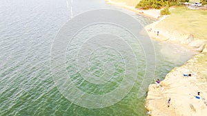 Top view white sand cliff with group of Asian men fishing at Lavon Lake, Texas, America