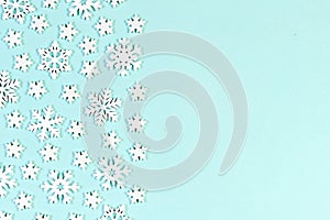 Top view of white snowflakes on colorful background. Winter weather concept with copy space. Merry Christmas concept