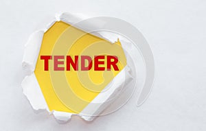 Top view of white torn paper and the text TENDER on a yellow background